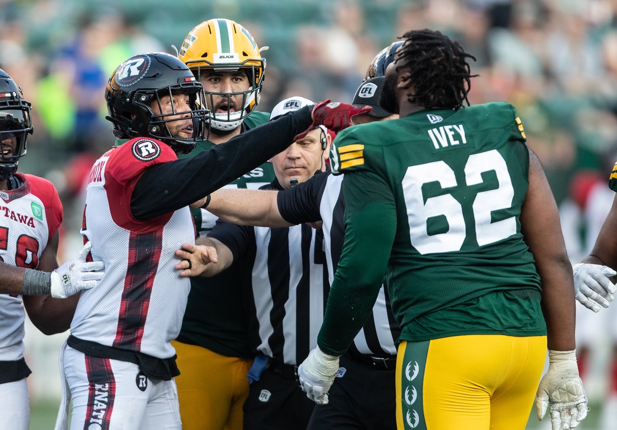 Elks left tackle Martez Ivey confrots Redblacks linebacker Jovan Santos-Knox following a play.